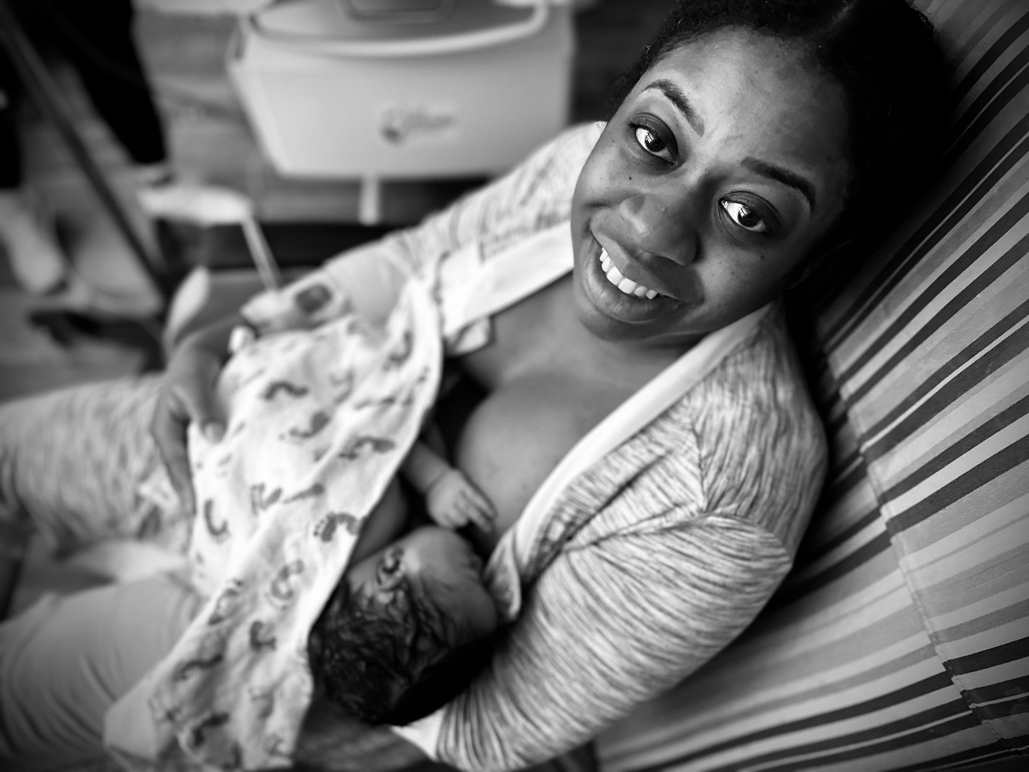 Mother smiling while holding newborn